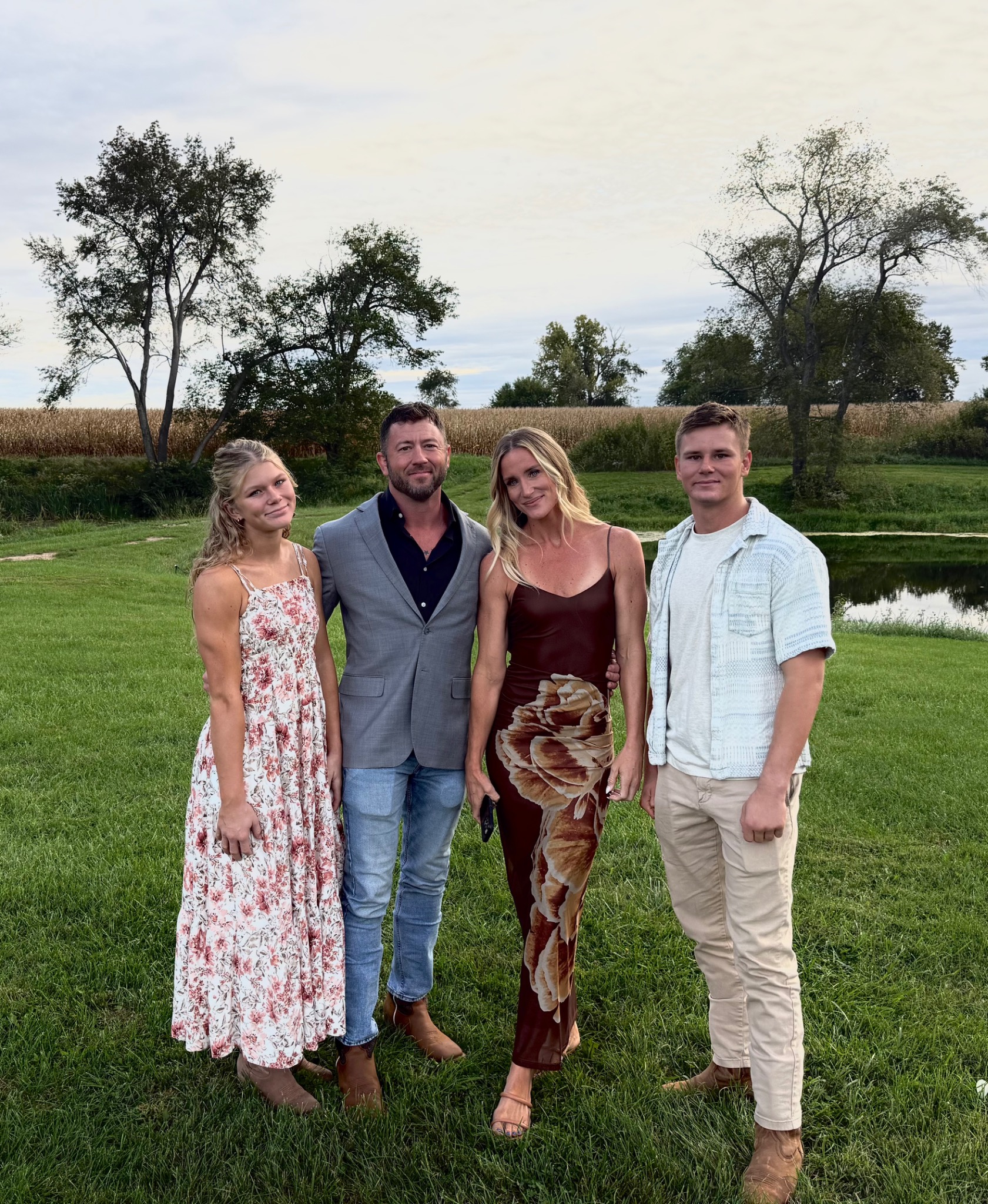 Jordon Bowen standing with a group outdoors beside a pond